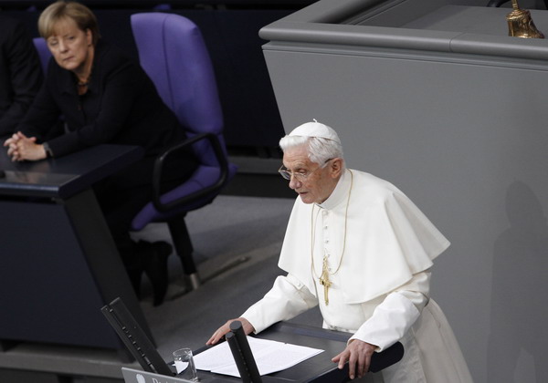 German Chancellor Angela Merkel (L) listens on as Pope Benedict XVI addresses the German Lower house of Parliament in the Reichstag on September 22, 2011 in Berlin, at the start of his first state visit to his native Germany. The 84-year old pope, German born Joseph Ratzinger, has a packed program, with 18 sermons and speeches planned for his four-day trip to Berlin, Erfurt in the ex-German Democratic Republic and Freiburg. AFP PHOTO / MICHELE TANTUSSI