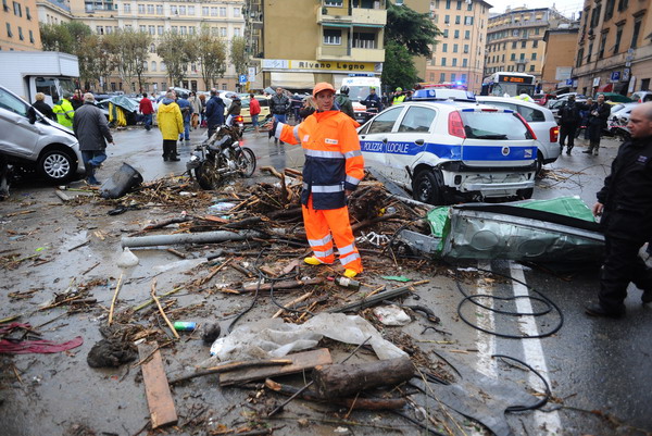 A rescuer stands amongst debris after the Bisagno river burst their banks during heavy rainfall on November 4, 2011 downtown Genoa. The Italian coastal city of Genoa was hit by floods, killing at least four people including one woman who was apparently crushed by cars being swept away by the water. AFP PHOTO / MASSIMO CEBRELLI