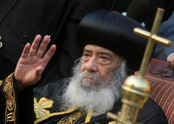 Pope Shenouda III (R), head of the Coptic Orthodox Church, Patriarch of Alexandria and the See of St. Mark, attends a ceremony held at the Al-Abbasiya church in Cairo on October 20, 2008, following his arrival from the US after medical treatment. Pope Shenouda, 85, returned to Egypt today after four months of convalescence in Cleveland, Ohia, in the US, after suffering a broken leg in a fall at the beginning of June. AFP PHOTO/KHALED DESOUKI