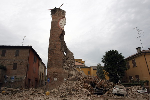 Cars are damaged after a tower collapsed following an earthquake on May 20, 2012 in Finale Emila. A powerful earthquake shook Italy's industrial and densely populated northeast early Sunday, killing three people and felling homes and church steeples around the historic city of Ferrara. AFP PHOTO / PIERRE TEYSSOT