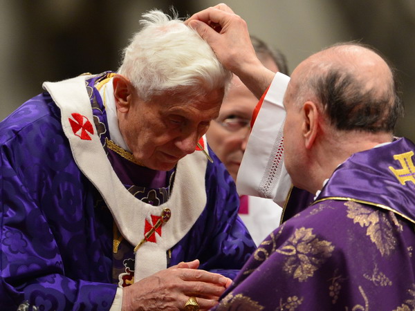 Pope Benedict XVI (L) receives ashes during the mass for Ash Wednesday, opening Lent, the forty-day period of abstinence and deprivation for the Christians, before the Holy Week and Easter, on February 13, 2013 at St Peter's basilica at the Vatican. Pope Benedict XVI made his first public appearance on Wednesday since his shock resignation announcement, asking thousands of cheering pilgrims at the Vatican to "keep praying for me".     AFP PHOTO / GABRIEL BOUYS
