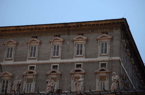 The shut windows of Pope Benedict XVI  appartments are seen from St. Peter's Square at the Vatican on March 01, 2013. Benedict XVI began his life of retirement by watching a bit of television, getting a good night's sleep and reciting the rosary, the Vatican said Friday, a day after his resignation.  AFP PHOTO / FILIPPO MONTEFORTE