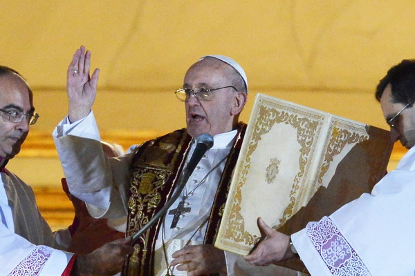 Argentina's Jorge Bergoglio, elected Pope Francis I (C) blesses faithful from the window of St Peter's Basilica's balcony after being elected the 266th pope of the Roman Catholic Church on March 13, 2013 at the Vatican.   AFP PHOTO / VINCENZO PINTO