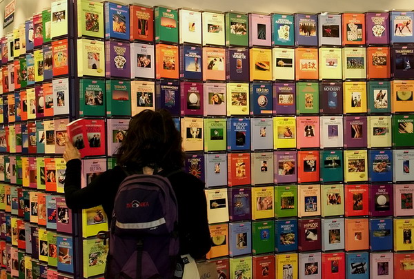 A visitor takes a book at a stand at the 50th Book Fair in Frankfurt, Germany, on Wednesday, October 7, 1998. Some 6,750 publishers present more than 369,000 titles until next Monday. The fair is open to the public on the weekend only. This time's focal theme is Switzerland. (AP Photo/Heribert Proepper)