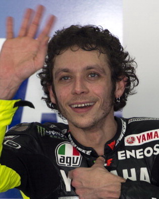 Yamaha MotoGP rider Valentino Rossi of Italy waves to his fans while getting ready for a ride on the first day of the pre-season motorcyling test at the Sepang circuit outside Kuala Lumpur on February 5, 2013. AFP PHOTO / Saeed Khan        (Photo credit should read SAEED KHAN/AFP/Getty Images)