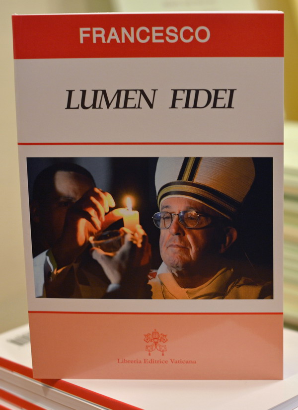 An edition of Pope Francis' first encyclical entitled "Lumen Fidei" is displayed during the press conference for the release of the encyclical on July 5, 2013 at the Vatican.  AFP PHOTO / GABRIEL BOUYS