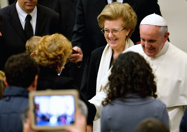RAI TV president Anna Maria Tarantola stands next to Pope Francis during an audience with a RAI TV delegation at the Paul VI hall in the Vatican on January 18, 2014. AFP PHOTO / VINCENZO PINTO