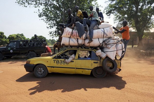 People leave the Damara, the last strategic town between the rebels from the SELEKA coalition and the country's capital Bangui, on January 2, 2013, as the commader of the regional African force FOMAC warned rebels against trying to take the town, saying it would "amount to a declaration of war." The rebels, who began their campaign a month ago and have taken several key towns and cities, have accused Central African Republic leader Francois Bozize of failing to honor a 2007 peace deal.  AFP PHOTO/ SIA KAMBOU        (Photo credit should read SIA KAMBOU/AFP/Getty Images)