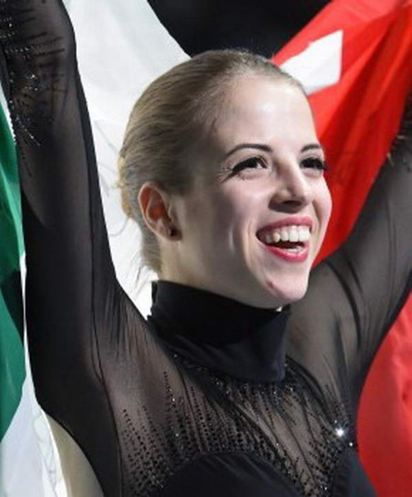 Italy's bronze medalist Carolina Kostner celebrates during the Women's Figure Skating Flower Ceremony at the Iceberg Skating Palace during the Sochi Winter Olympics on February 20, 2014.  AFP PHOTO / DAMIEN MEYER        (Photo credit should read DAMIEN MEYER/AFP/Getty Images)