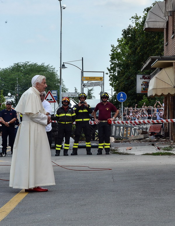 Pope Benedict XVI prays in front of St. Catherine church as he arrives  on June 26, 2012 in Rovereto sulla Secchia, in Modena, the region in northeast Italy hit by two deadly earthquakes in May.  Over 15,000 people were left homeless after the quakes on May 20 and 29, and just over 14,000 are still living in emergency structures, including schools, barracks and 37 tent camps, according to Italy's Civil Protection Agency. AFP PHOTO /  ANDREAS  SOLARO