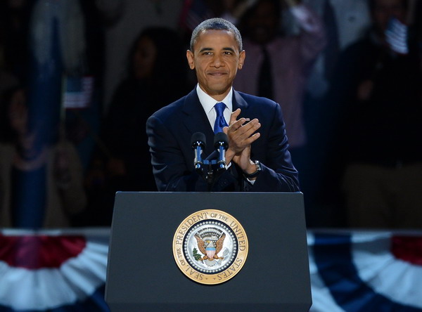 US President Barack Obama claps as he arrives on stage to deliver his acceptance speech on November 7, 2012 in Chicago. Obama swept to re-election, forging history again by transcending a slow economic recovery and the high unemployment which haunted his first term to beat Republican Mitt Romney.      AFP PHOTO / Saul LOEB