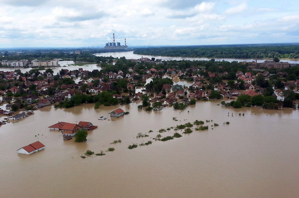This image made available by the Serbian police shows the flooded area in Obrenovac, some 30 kilometers (18 miles) southwest of Belgrade, Serbia, Sunday, May 18, 2014. In Serbia, more than 20,000 people have been forced from their homes. Officials there fear more flooding later Sunday as floodwaters travel down the Sava and reach the country. Serbian officials said that the flood wave might be lower than initially expected, because the river broke barriers upstream in Croatia and Bosnia. Experts said they expect Sava floodwaters to rise for two more days, then subside. (AP Photo/Serbian Police)