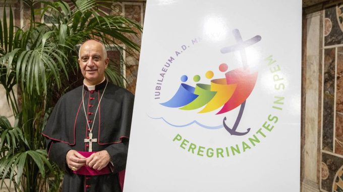 Monsignor Rino Fisichella e il logo (foto Siciliani / Gennari / Sir)