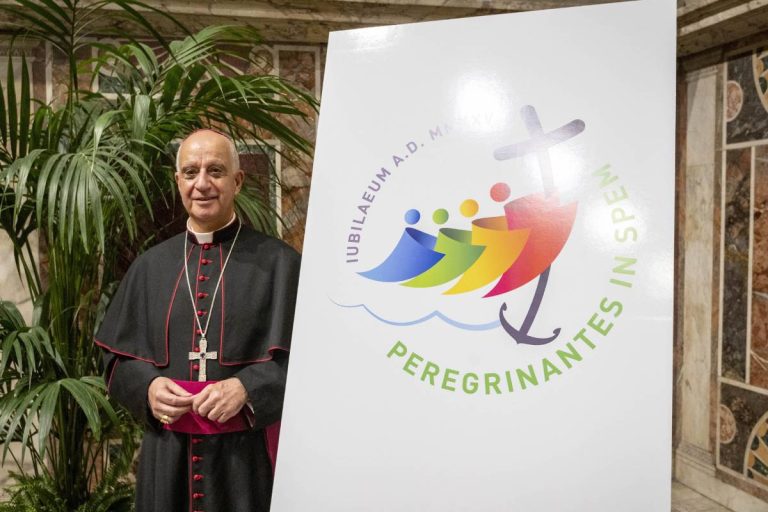 Monsignor Rino Fisichella e il logo (foto Siciliani / Gennari / Sir)